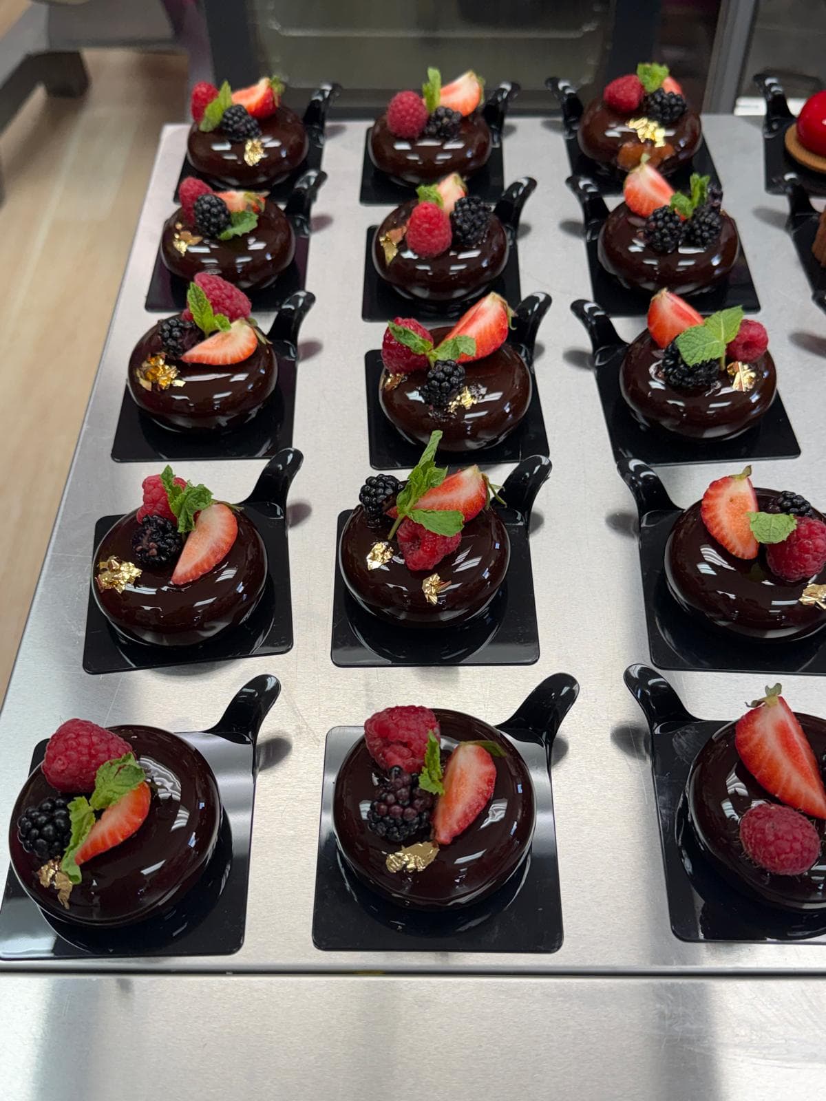 Chocolate desserts finished with berries and gold leaf